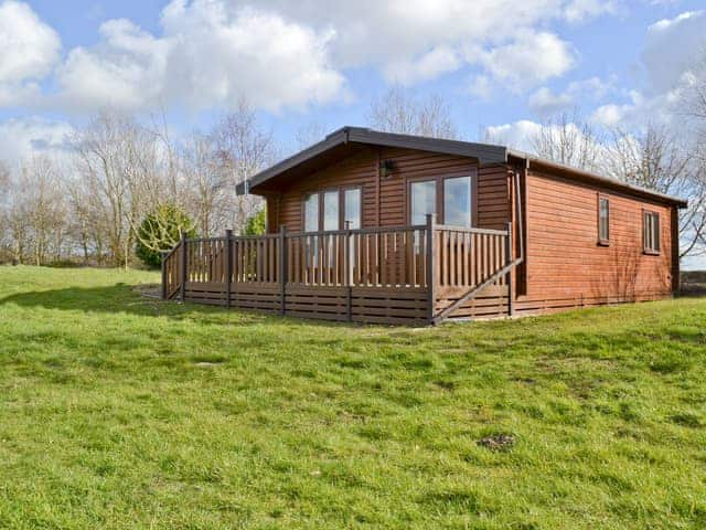 Attractive log cabin style lodge with balcony set in lovely countryside | Glebe Pine Lodge - Glebe Farm Apartments and Lodge, West Barkwith, near Market Rasen