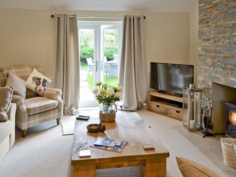 Spacious lounge with French doors leading to garden | Willow Tree Cottage at Cottage Farm - Cottage Farm, Foxholes, near Scarborough