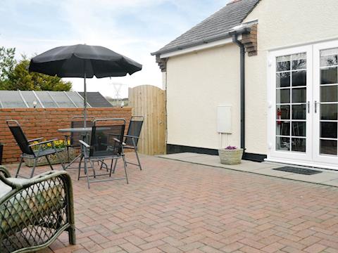 Rear patio/ courtyard | The Snug, Caergeiliog, near Holyhead