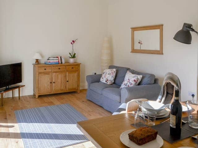 Living room area with French doors leading to patio area | The Old Workshop, Rock near Alnwick