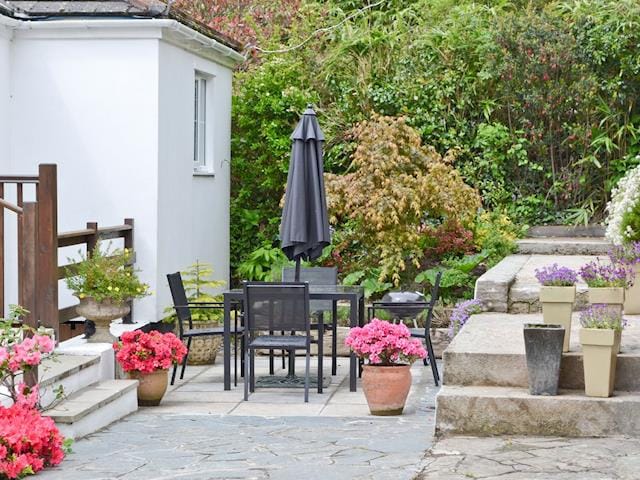 Inviting patio with furniture and barbecue | River Lodge, Polperro, near Looe