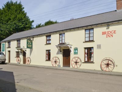 The flat is on the upper floor of the Bridgerule village pub on the left of the image | The Bridge Inn Apartment, Bridgerule, near Bude