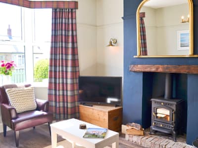 Cosy living room with wood burner | Driftwood Cottage, Seahouses