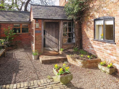 The gravelled approach to the charming brick-built cottage | The Coach House - Berrington House, Tenbury Wells