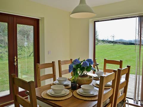 Well presented dining area overlooking the grassed area | Cinder Warren, Whitby