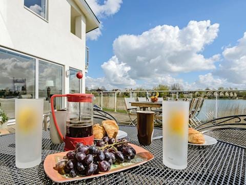 Enclosed decked garden with a super lakeside view | Squirrels Leap, Somerford Keynes, near Cirencester