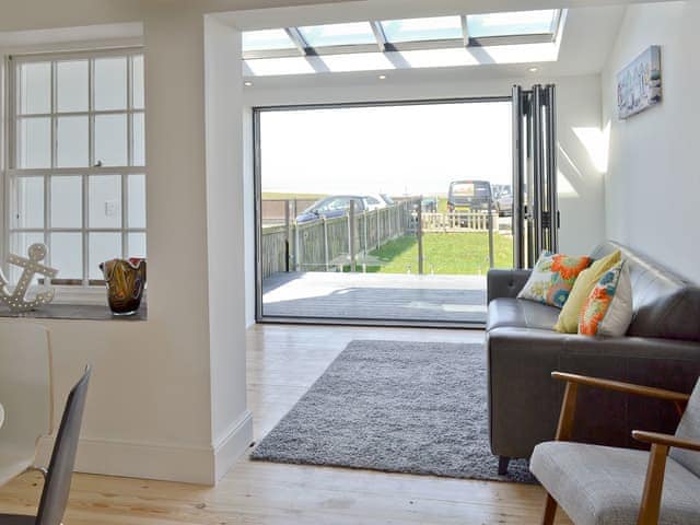 Living area, leading through to the bi-folding doors and the views beyond | Coastguard Cottage, Swalecliffe, near Whitstable