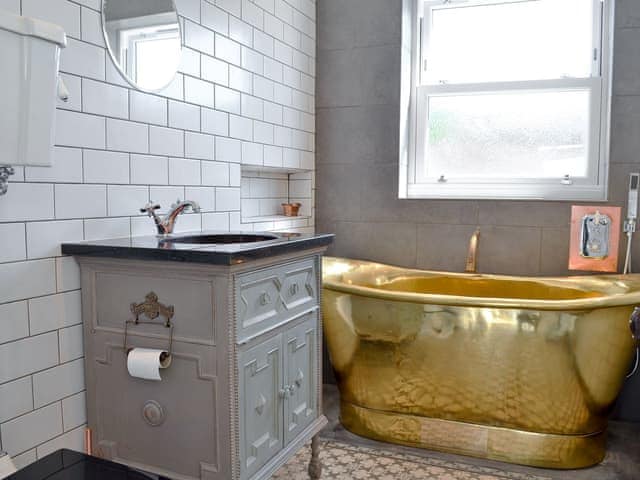 High-spec bathroom includes rare brass bath and copper sink | Coastguard Cottage, Swalecliffe, near Whitstable