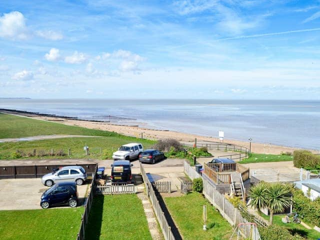 Stunning views, showing the garden and the nearby beach | Coastguard Cottage, Swalecliffe, near Whitstable