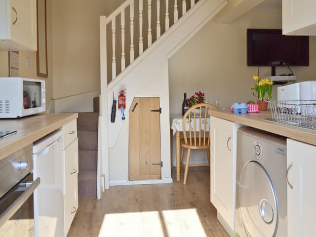 Galley style kitchen with stairs to upper level | Egmont Farm - The Hayloft - Egmont Farm , Northiam, near Rye