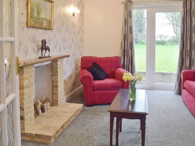 Living room with French doors out to the garden | Glebe Cottage, West Caister, near Great Yarmouth