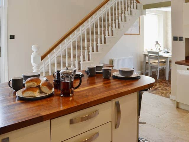 The spacious dining/kitchen area has a wood-topped breakfast bar | Island View, Amble