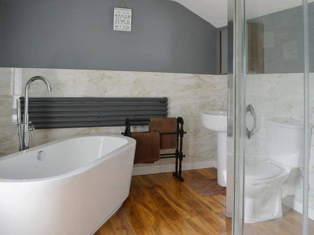 The stylish modern bathroom has a standalone bath and walk-in shower | Island View, Amble