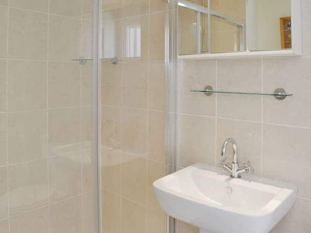 The ground floor shower room is fully tiled | Island View, Amble