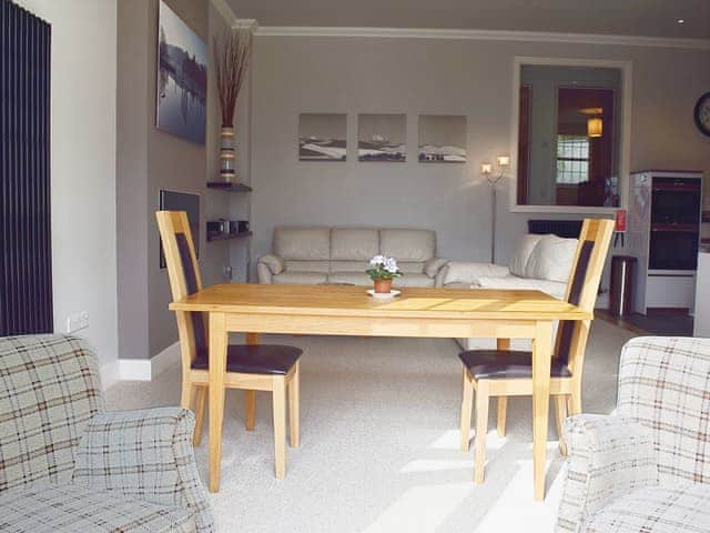 The well proprtioned dining table sits in a prominent position in the open living area | 7 Ladstock Hall - Ladstock Hall, Thornthwaite