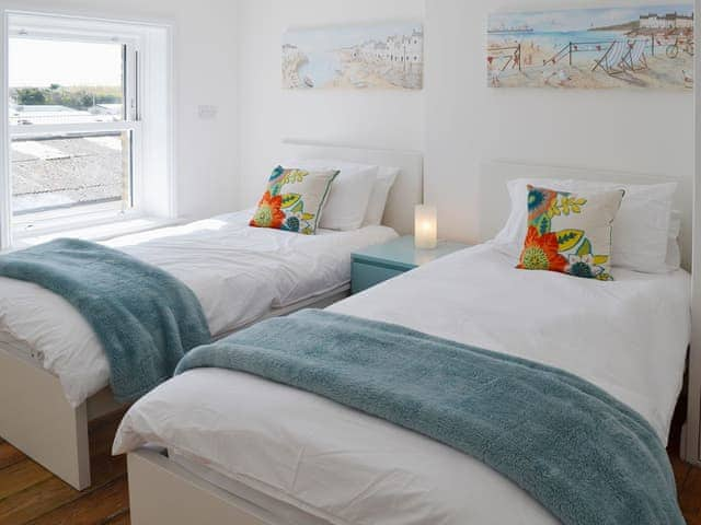 Twin bedroom with contemporary decor and crisp white linen | Coastguard Cottage, Swalecliffe, near Whitstable