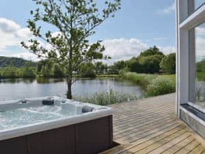 Open deck with large hot tub | Heron Lodge, Five Roads, near Llanelli