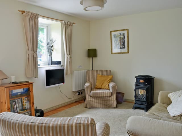 Homely living room with gas flame-effect fire | Mews Cottage, Middleton-in-Teesdale
