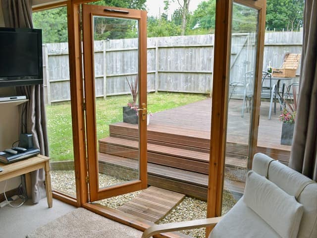 Homely living room with French doors to patio | Blackthorn Cottage, Swan Pool, near Falmouth