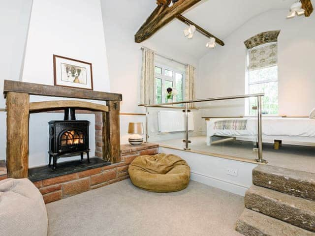 Luxurious split level room with beams, king size bed and wood burner | The Old Mill, Great Strickland near Penrith