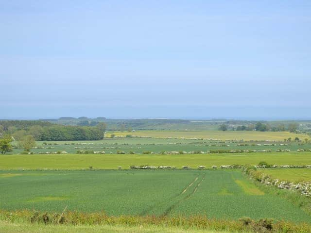 There is a fine view across the rolling countryside to the North Sea coast | Etive Cottage, Warenford, near Belford