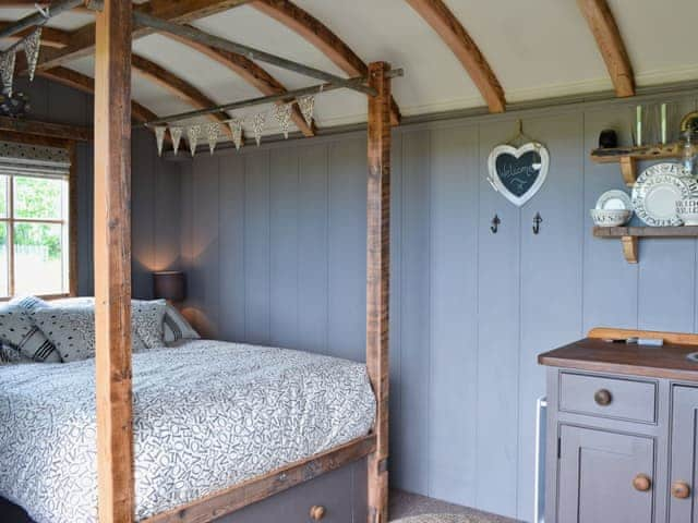 Bed room area with four poster double bed | The Swaledale - West Hale Shepherd&rsquo;s Huts, Burton Fleming, near Filey