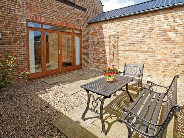 Enclosed private patio area with outdoor furniture | The Granary, North Somercotes, near Louth