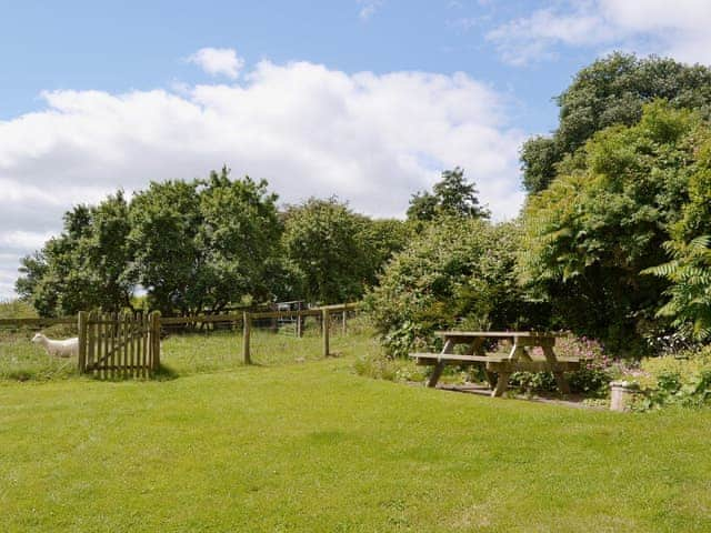 The large lawned garden has a picnic-style outdoor eating area | The Oast House, Whatmore, near Tenbury Wells