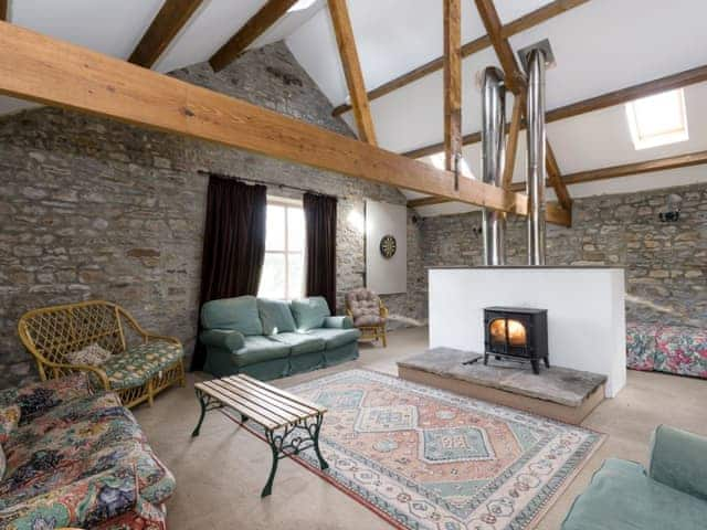 Spacious seating area with wood burner within recreation room | Cowdber Barn, Burrow, Kirkby Lonsdale