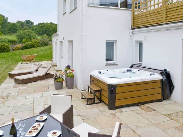 Patio with outdoor furniture and hot tub | Honey Pippin - Horselake Farm Cottages, Cheriton Bishop