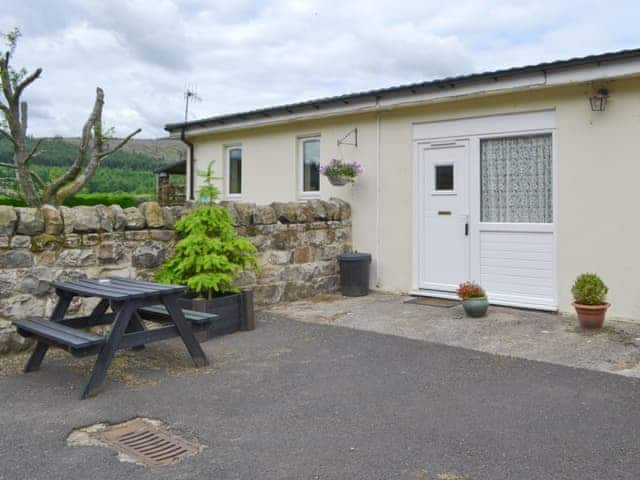 Courtyard with picnic table | Stable Cottage - Border Forest Cottages, Cottonshopeburnfoot, near Otterburn