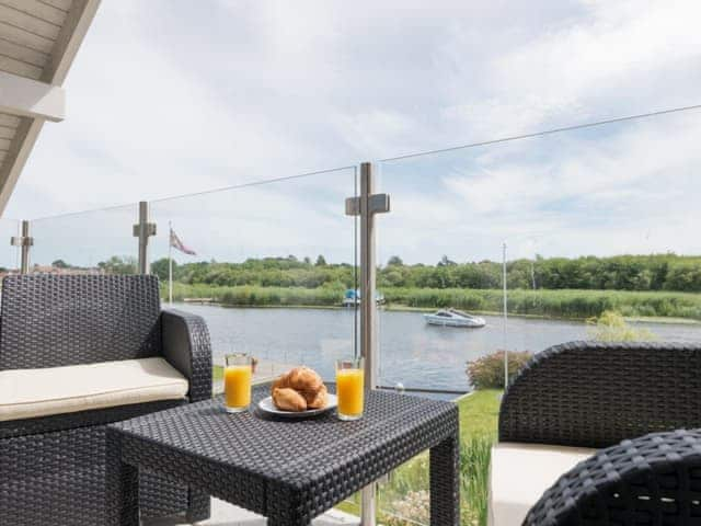 Outdoor furniture on master suite balcony | Silver Dawn, Horning, near Wroxham