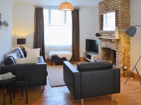 Wood-floored living area with open fireplace | Stockwell Street, Cambridge