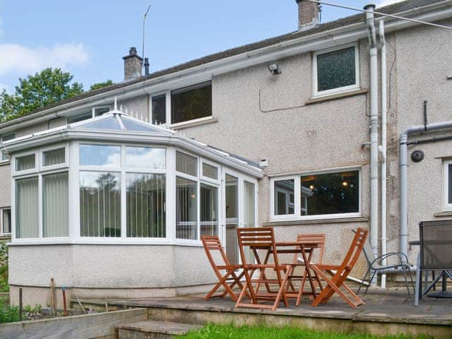 Raised patio area adjacent to the conservatory | Briar Rigg, Keswick