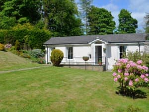 Exterior and large lawned garden | Cameron Lodge Cottage, Innellan, near Dunoon