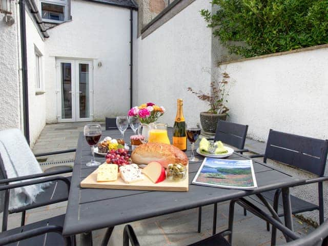 Enclosed courtyard with outdoor furnishings | Tommy&rsquo;s Cottage, Keswick