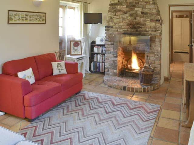 Homely living room with open-fire in feature fireplace | The Bothy - The Dovecote, Staple, near Wingham