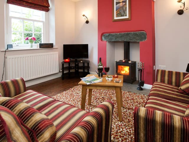 Traditional living area with open fireplace | 22 Rose Terrace, Keswick