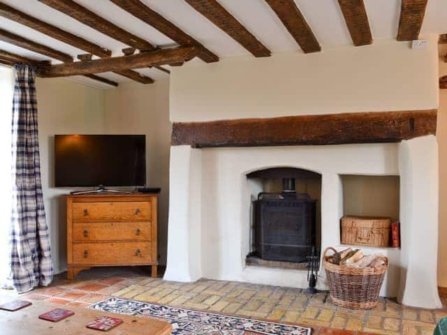 Living room with wood burning stove | The Pightle - Church Farm Cottages, South Acre