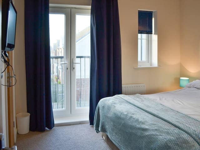 Double bedroom with Juliette balcony | Puffin Place, Beadnell, near Seahouses