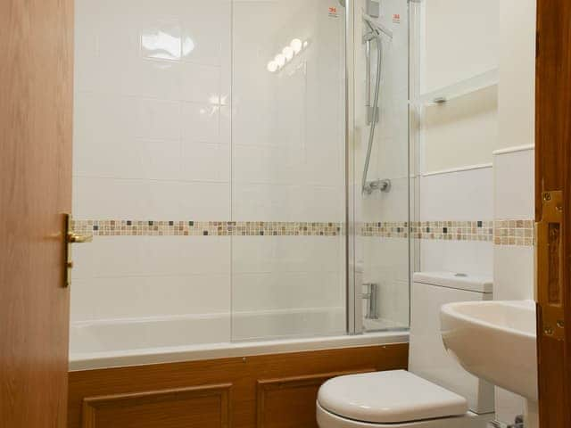 Bathroom with shower over bath | 1 Lonsdale House - Greta Grove Apartments, Keswick