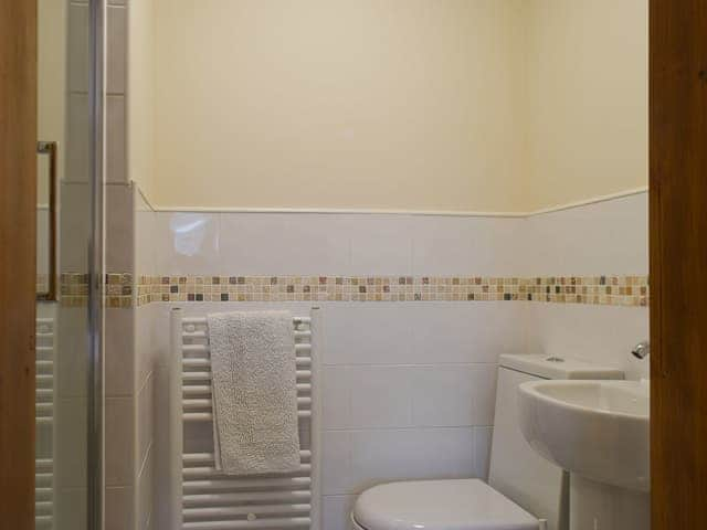 En suite shower room with heated towel rail | 1 Lonsdale House - Greta Grove Apartments, Keswick