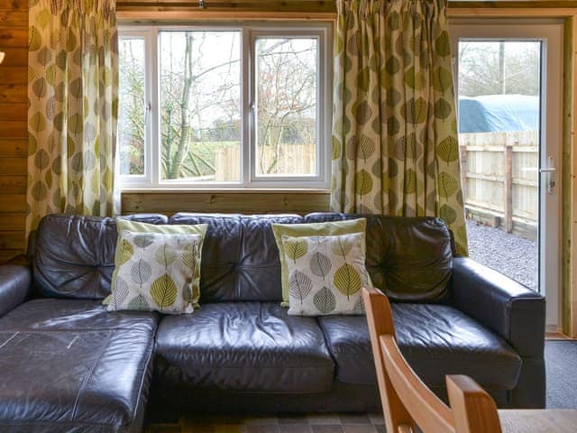 Useful dining table in living area | Treehouse Cabin - Wallace Lane Farm Cottages, Brocklebank, near Caldbeck and Uldale