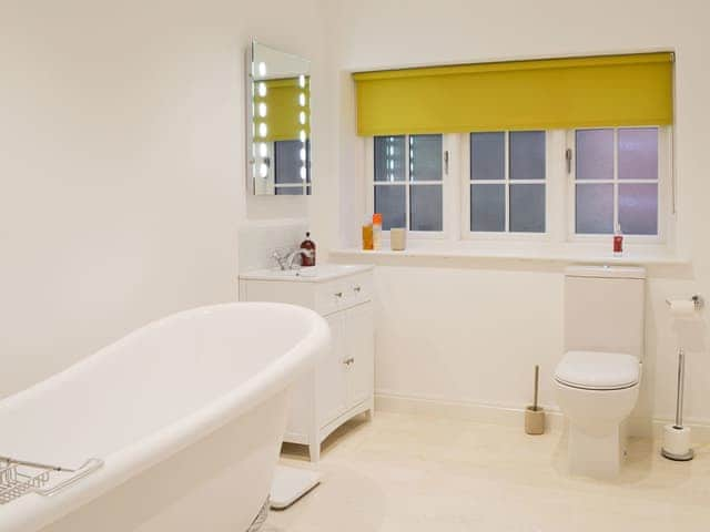 Bathroom with rolltop bath and heated towel rail | The Coach House, White Moss, near Grasmere