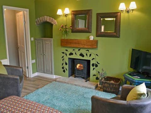 Warm and welcoming living room with wood burner | Nutmeg Cottage, Tideswell, near Buxton