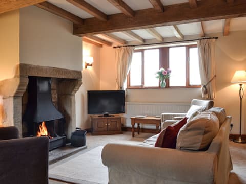 Cosy living room with open fire & exposed beams | Blue Plain Cottages No 2, Glasshouses, near Pateley Bridge