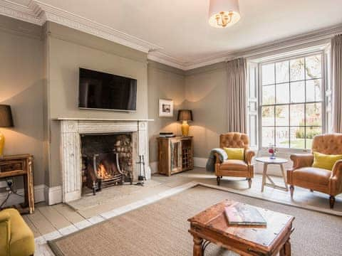 Elegant and warm living room with open fire | The Manor House, Syderstone, near Fakenham