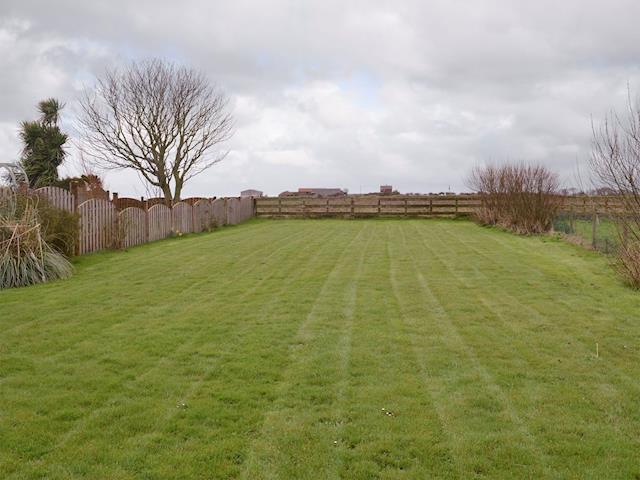 Enclosed lawned garden with open rural views beyond | Homebay, Flamborough