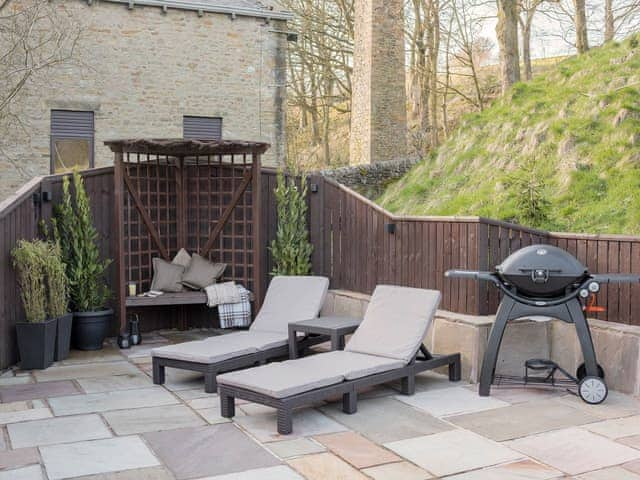 Paved patio with a range of seating options and a BBQ | Narrowgates Cottage, Barley, near Barrowford