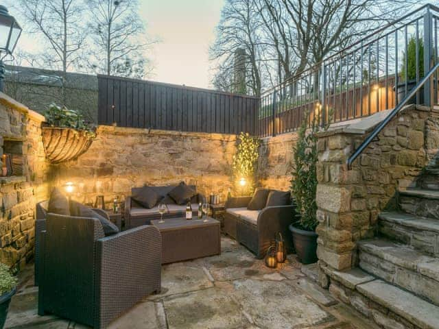 Sheltered area of patio illuminated for the evening | Narrowgates Cottage, Barley, near Barrowford